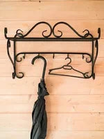 Vintage wall mounted metal coat rack with hooks and top shelf for entryway storage