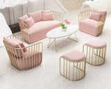 Pink and gold modern furniture set in a living room.

