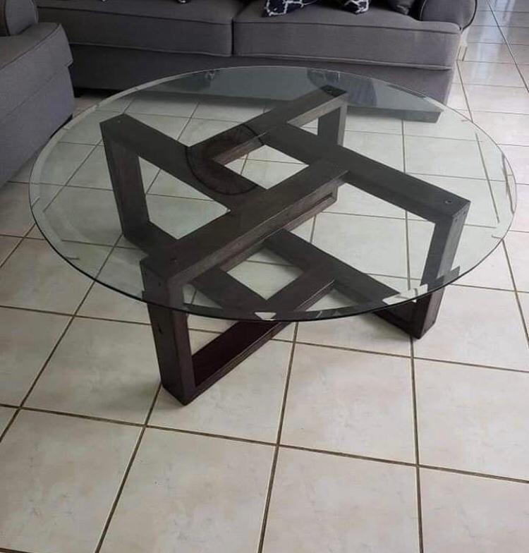 Round glass coffee table with geometric metal base