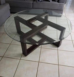 Round glass coffee table with geometric metal base