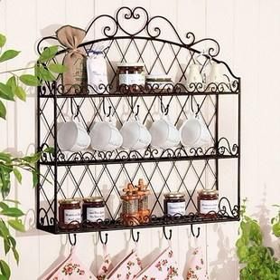 Vintage black wall-mounted spice rack with hooks and jars