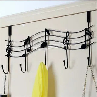 Wall-mounted coat rack with music note design and hooks